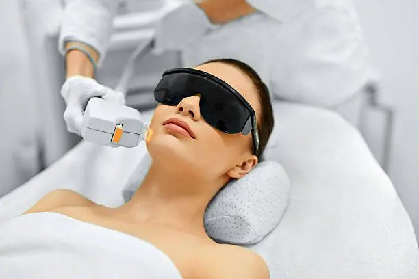 a woman receiving laser treatments